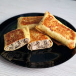 Thin Pancakes Stuffed with Meat and Mushrooms